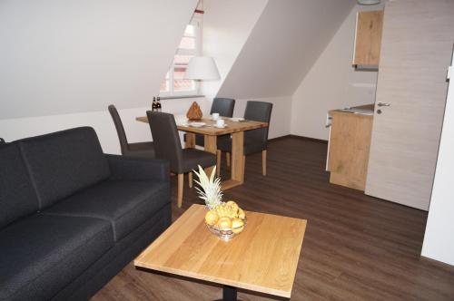 a living room with a couch and a table at Braumeister Döbler - Ferienwohnungen in Bad Windsheim