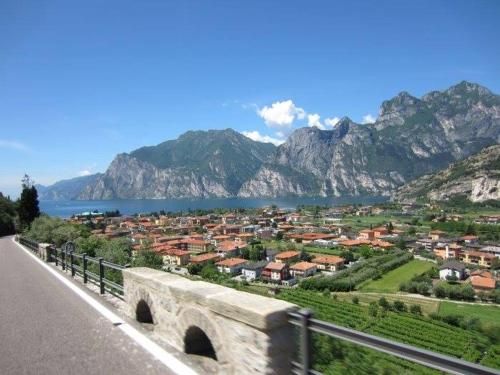 a town on the side of a road with mountains at Appartamento Ellen in Nago-Torbole