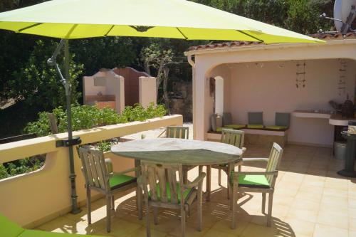 a table and chairs under an umbrella on a patio at Domise in Conca