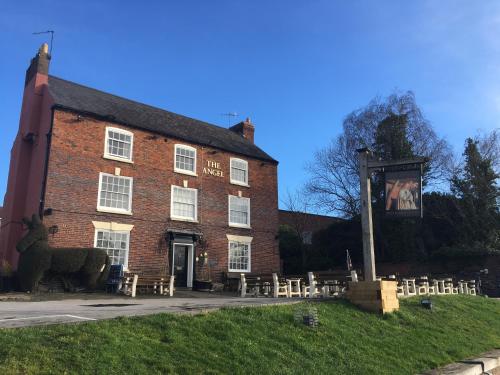 a large brick building with tables and chairs in front of it at The Angel Inn Stourport in Stourport
