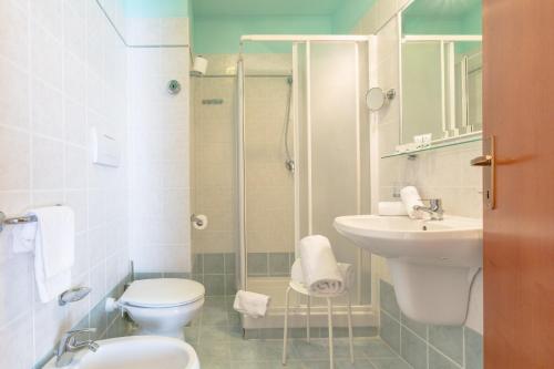 a bathroom with a toilet and a sink and a shower at Hotel Traiano in Civitavecchia