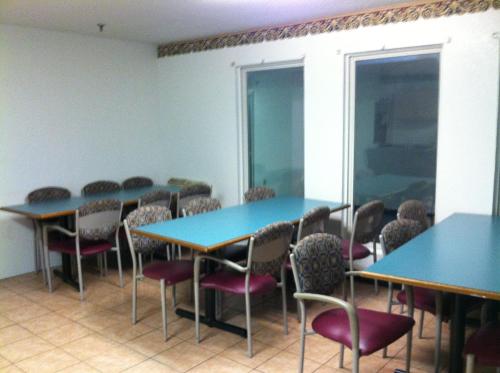 a conference room with blue tables and chairs at Budget Inn Wentzville in Wentzville