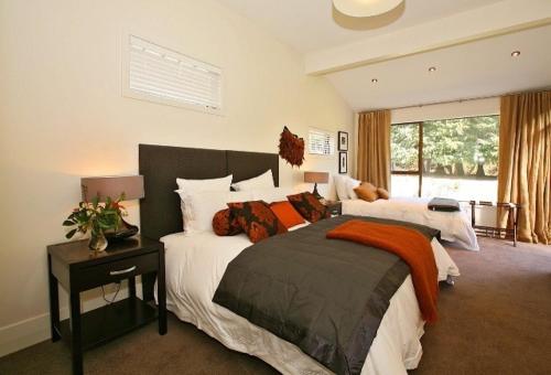 a bedroom with a large bed and a window at Waiorau Homestead in Cardrona
