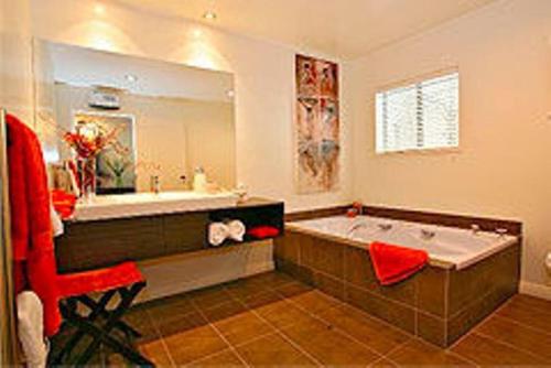 a large bathroom with a tub and a sink at Waiorau Homestead in Cardrona