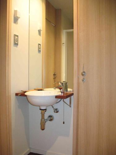 a bathroom with a white sink and a mirror at Apartamento playa Illa de Arousa in Isla de Arosa