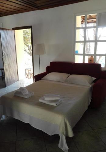 a bedroom with a large bed with towels on it at Trouli House in Stalos