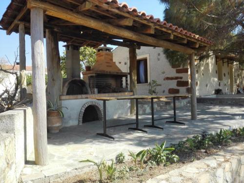 a patio with an outdoor oven in a house at Trouli House in Stalos