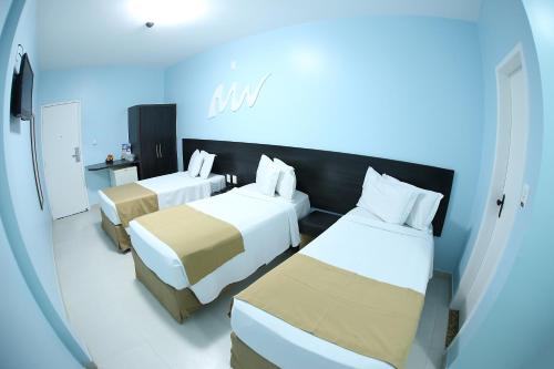 a room with two beds in a hospital room at Real Praia Hotel in Aracaju