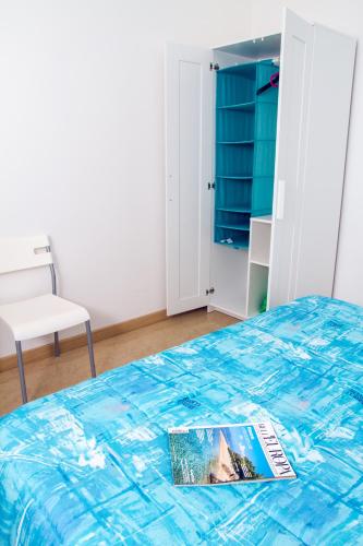 a bedroom with a bed with a magazine on it at Casa Stoccolma in Pozzallo