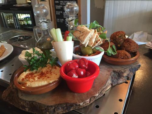 a table topped with bowls of food on a table at Castle Hotel in Eynsford
