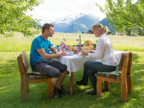 a man and a woman sitting at a table at Appartement-Pension Fahrnberggut in Rauris