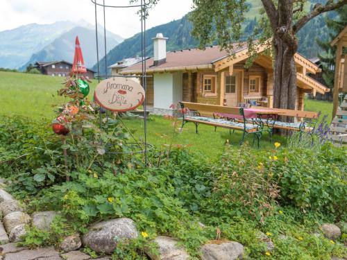 a sign in a garden in front of a house at Appartement-Pension Fahrnberggut in Rauris