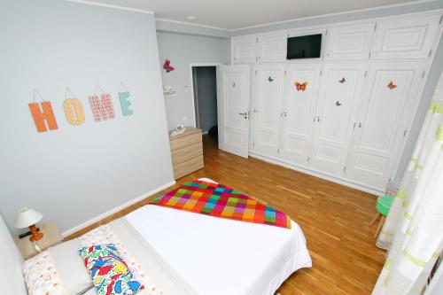 a small bedroom with a bed and white cabinets at Guest House Pereira in Vila Praia de Âncora