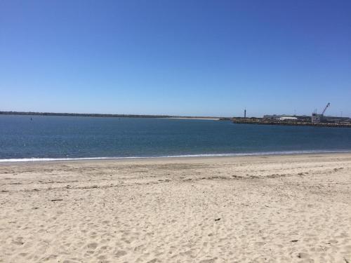 a sandy beach with the ocean in the background at Viana do Castelo, Cabedelo Beach Apartment in Viana do Castelo
