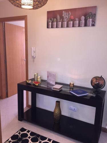 a black desk in a room with a wall at Viana do Castelo, Cabedelo Beach Apartment in Viana do Castelo