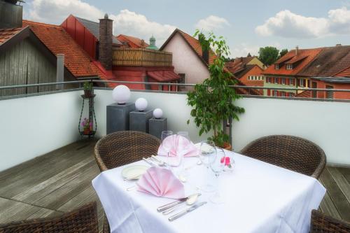 a table with a white table cloth on a balcony at Hotel Alte Post in Wangen im Allgäu