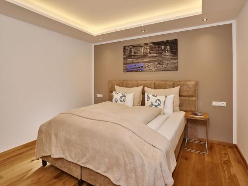 a bedroom with a large bed with pillows at A-VITA Viktoria & A-VITA living luxury apartments in Seefeld in Tirol