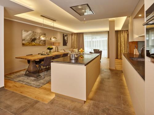 a kitchen and dining room with a table and a dining room at A-VITA Viktoria & A-VITA living luxury apartments in Seefeld in Tirol