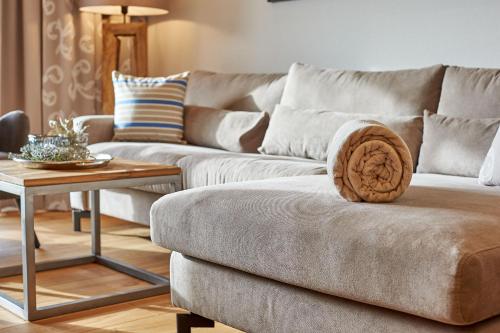 a living room with a couch and a table at A-VITA Viktoria & A-VITA living luxury apartments in Seefeld in Tirol