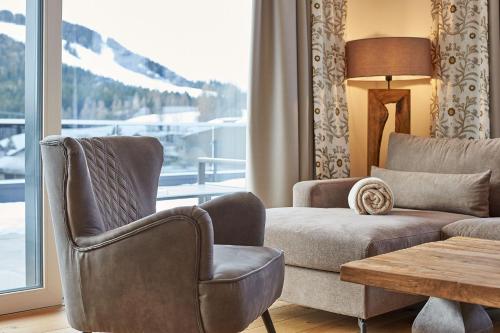 a living room with a couch and a chair at A-VITA Viktoria & A-VITA living luxury apartments in Seefeld in Tirol