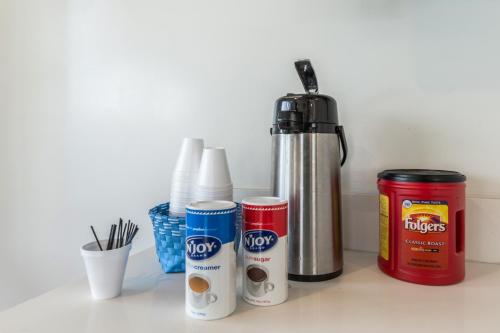 a counter with a thermos and condiments on it at Pacific Inn in Oceanside