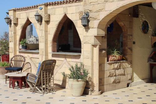 an outdoor patio with two chairs and a table at Osiris Hotel Cairo in Cairo