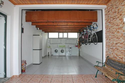a hallway with a bench and appliances in a house at Guest House Pereira in Vila Praia de Âncora