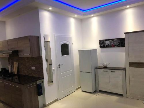 a kitchen with a blue light on the ceiling at Pension / Zimmervermietung Wasbek in Wasbek