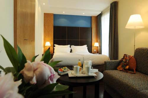 a hotel room with a bed and a table at Best Western Plus Monopole Métropole in Strasbourg