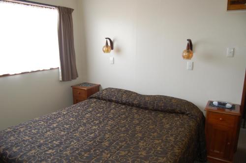 En eller flere senge i et værelse på Carisbrook Motel