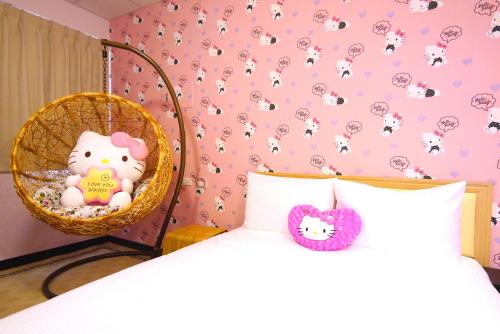 a bedroom with a bed and a basket with a stuffed animal at Traveler Station in Kaohsiung