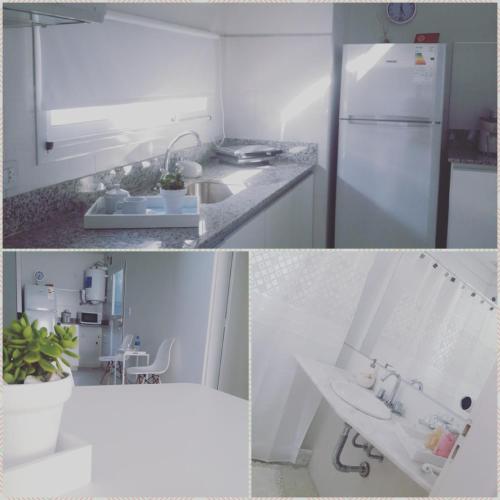 a white kitchen with a sink and a refrigerator at Complejo Pirovano in Lincoln