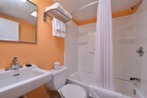 a bathroom with a sink and a toilet and a shower at Media Inn & Suites in Media