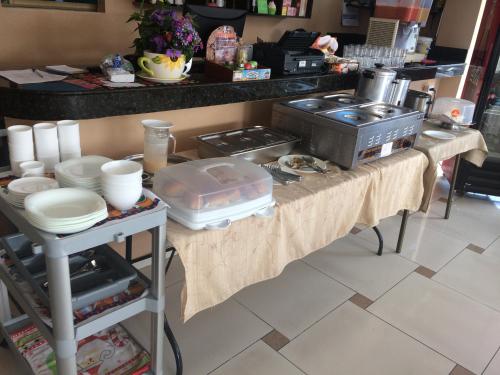 a kitchen with a table with some food on it at Hotel Garzota Inn in Guayaquil