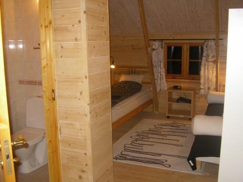 a small room with a bed and a bathroom at Pensionat Sågknorren in Bygget