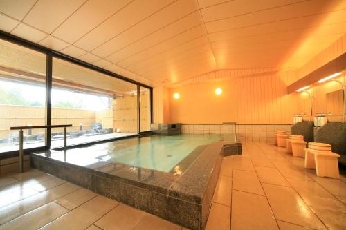 a swimming pool in a large room with at Mikasa in Nara