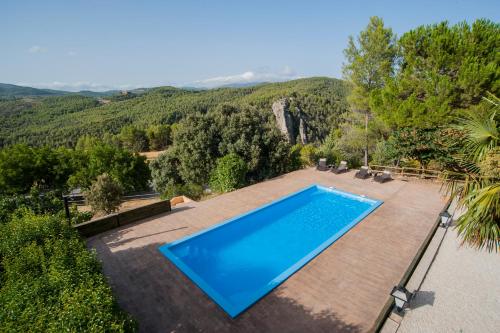an outdoor swimming pool with a view of the mountains at Casa Bons Aires - adults only in Alcoy
