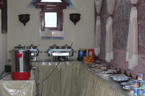 a kitchen with a counter with two stove tops at Osiris Hotel Cairo in Cairo