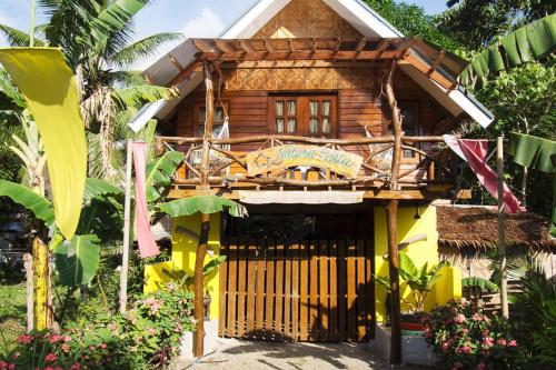 a wooden house with a gate in front of it at Natura Vista in Panglao