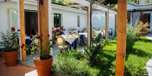 a patio with a table and chairs in the yard at Casa Vacanze Vittoria in Ravello