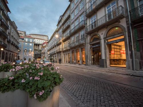 a city street with buildings and flowers at Hotel Carris Porto Ribeira in Porto