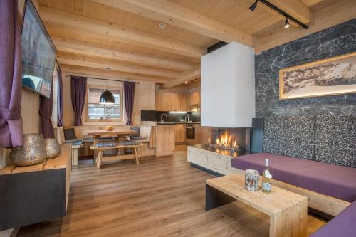 a living room with a couch and a table at Alpenchalet Stadlpoint in Ried im Zillertal