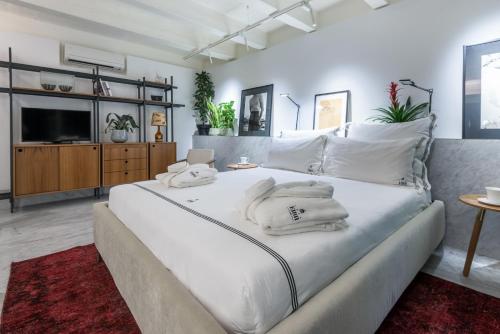a bedroom with a large white bed with towels on it at Casa Ellul - Small Luxury Hotels of the World in Valletta