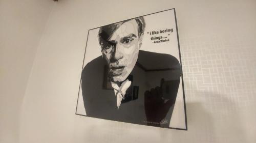 a picture of a man in a suit and tie on a wall at Dalbit stay Seodaejeon in Daejeon