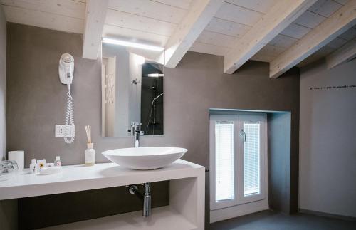 a bathroom with a white sink and a mirror at CHARMING MOMENT di Villa Porta - Residenza Felice in Luino