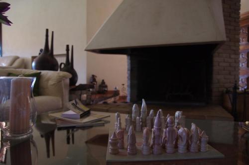 a chess set on a table in a living room with a fireplace at A Casa Di Angela B&B in Carbonia