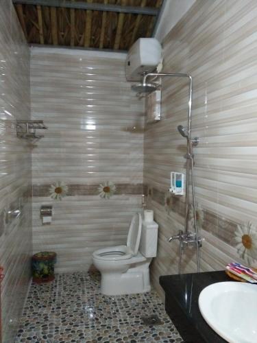 a bathroom with a toilet and a sink at Tam Coc Palm House in Ninh Binh
