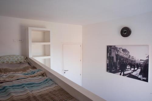 a white room with a bed and a shelf at BoardXhouse in Imsouane