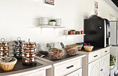 a kitchen with a counter with bowls of food at Résidence Azurea in Aix-les-Bains