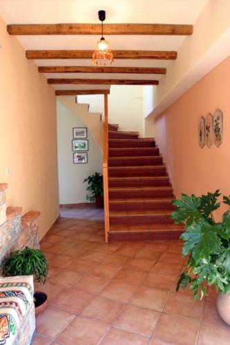 a hallway with a staircase in a house at Chiliadromia Studios in Alonnisos Old Town
